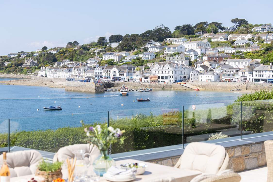 To the right the pretty village centre, to the left across the water to Place Manor and St Anthony headland.