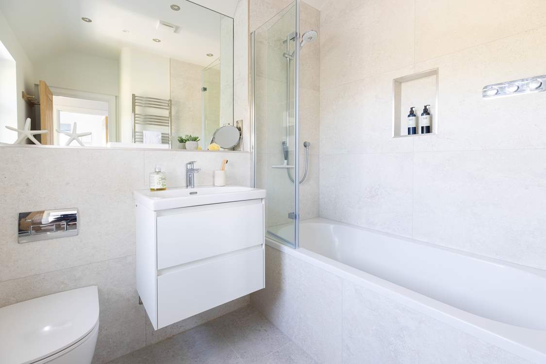 The family bathroom has a bath with shower over, ideal for a long soak.