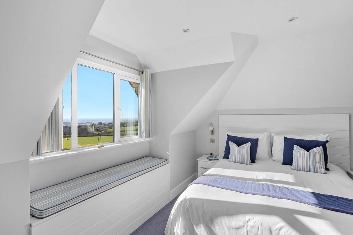 Bedroom 5 has a king-size bed and a single bed, perfect for a small family within the larger group.