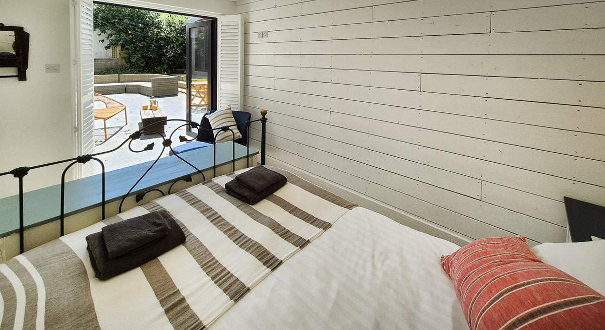 This gorgeous double bedroom is on the ground floor with doors leading to the patio.