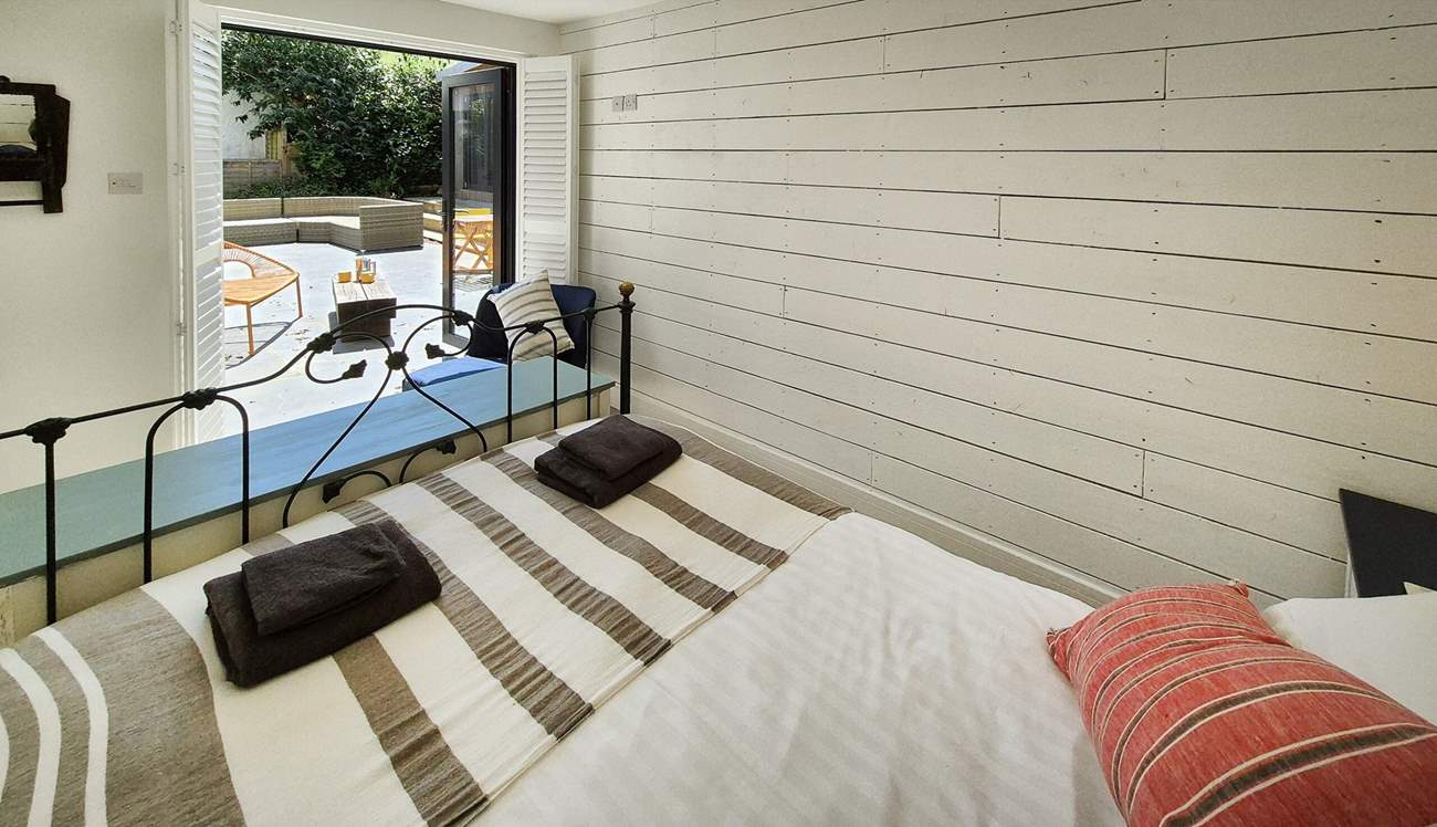 This gorgeous double bedroom is on the ground floor with doors leading to the patio.