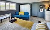 This spacious bedroom has a sofa too.  - Thumbnail Image