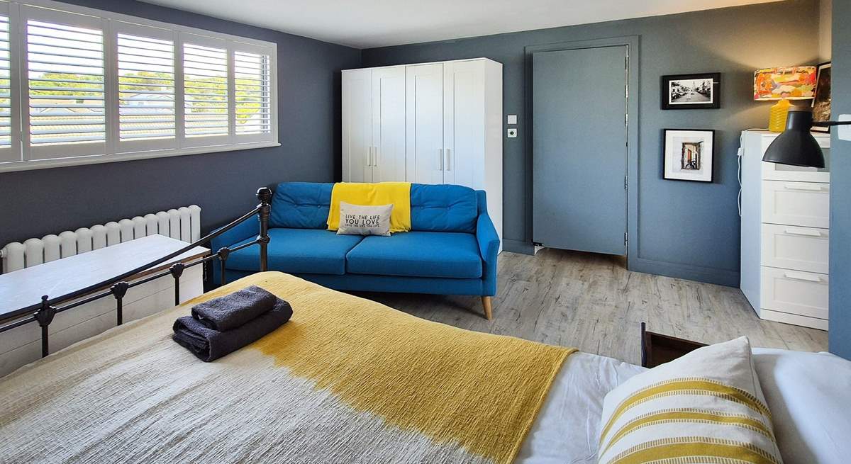 This spacious bedroom has a sofa too. 