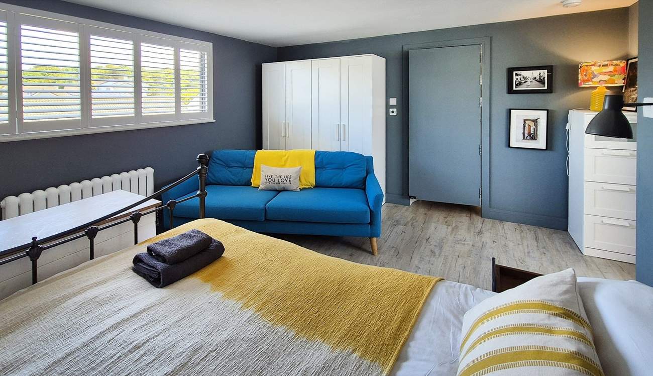 This spacious bedroom has a sofa too.