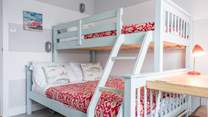 The perfect bright bunk bed room with a double bed on the bottom and a single on top.