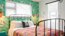 A delight on the eye and a true holiday room with an en suite cloakroom.