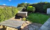 The garden area has a table for al fresco dining and a hot tub for relaxing after a busy day. - Thumbnail Image