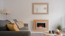 The sitting-room has a pebble-effect electric fire for cosy evenings.