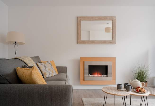 The sitting-room has a pebble-effect electric fire for cosy evenings.