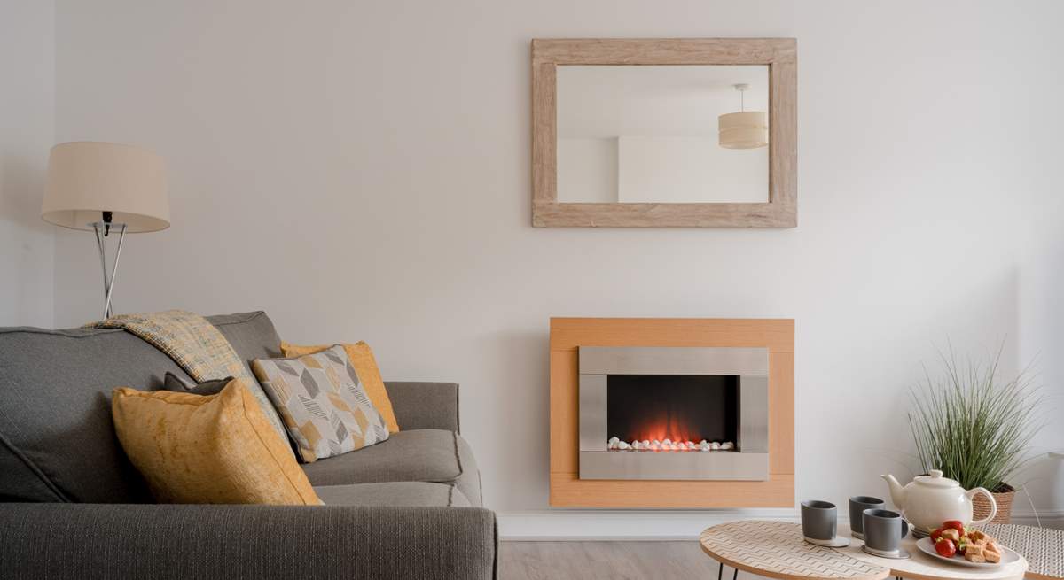 The sitting-room has a pebble-effect electric fire for cosy evenings.