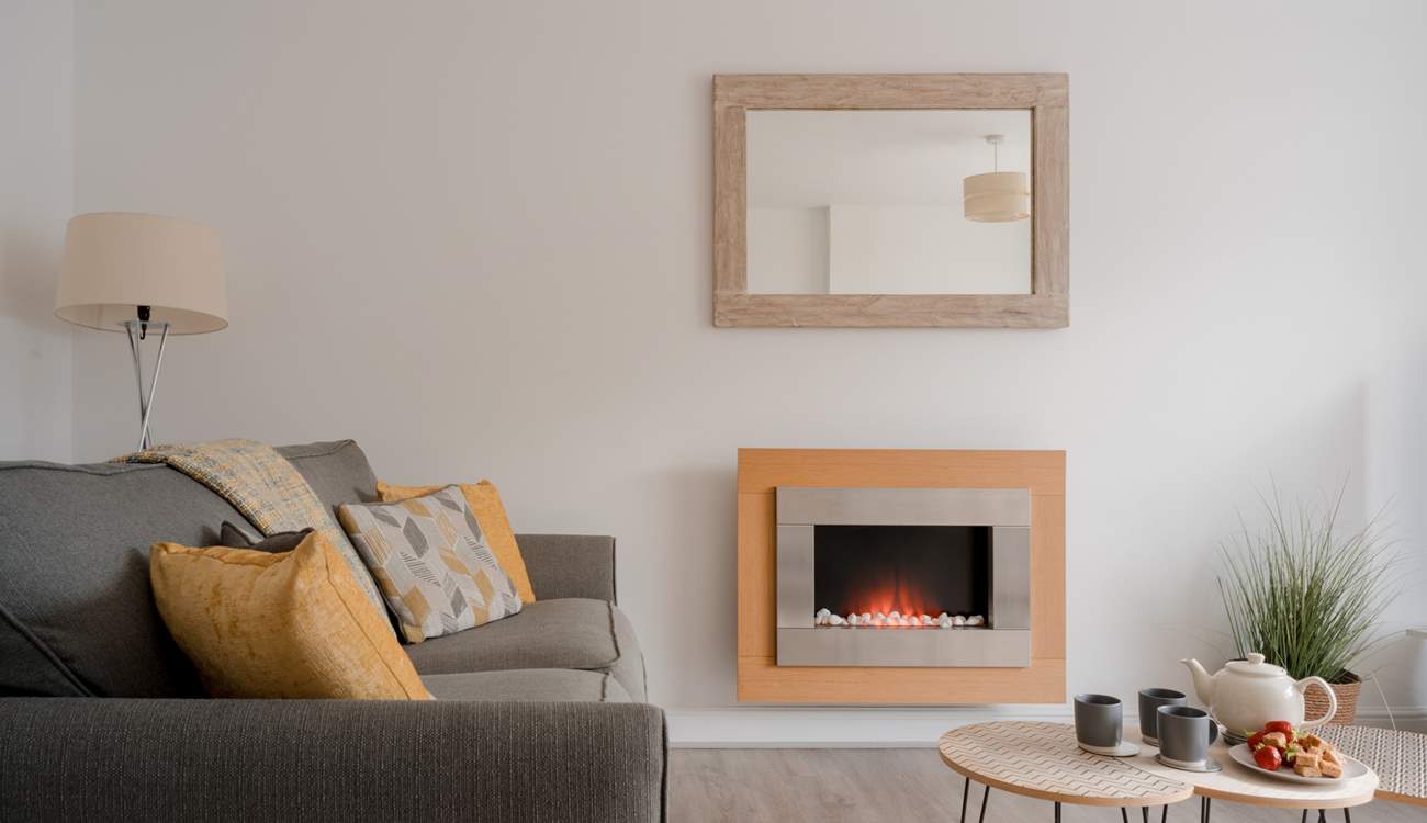 The sitting-room has a pebble-effect electric fire for cosy evenings.