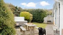 The garden area has a table for al fresco dining.
