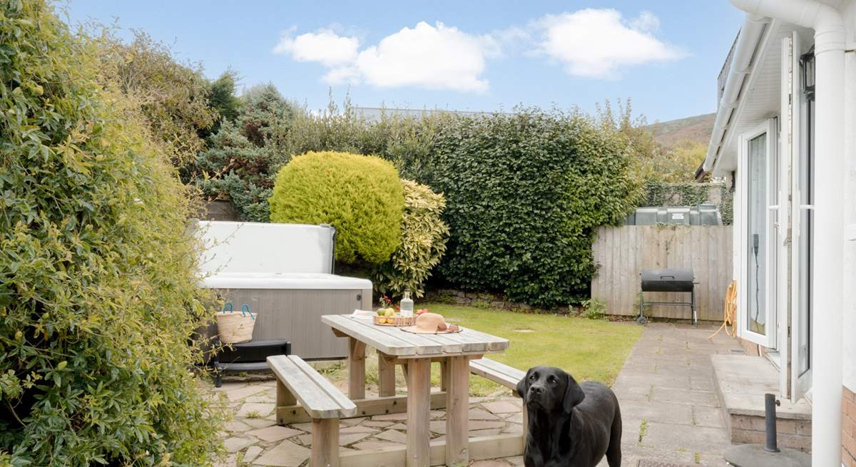 The garden area has a table for al fresco dining.