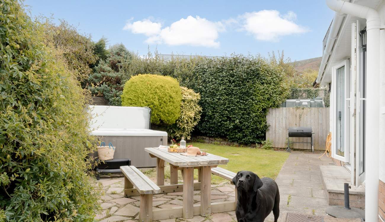 The garden area has a table for al fresco dining.