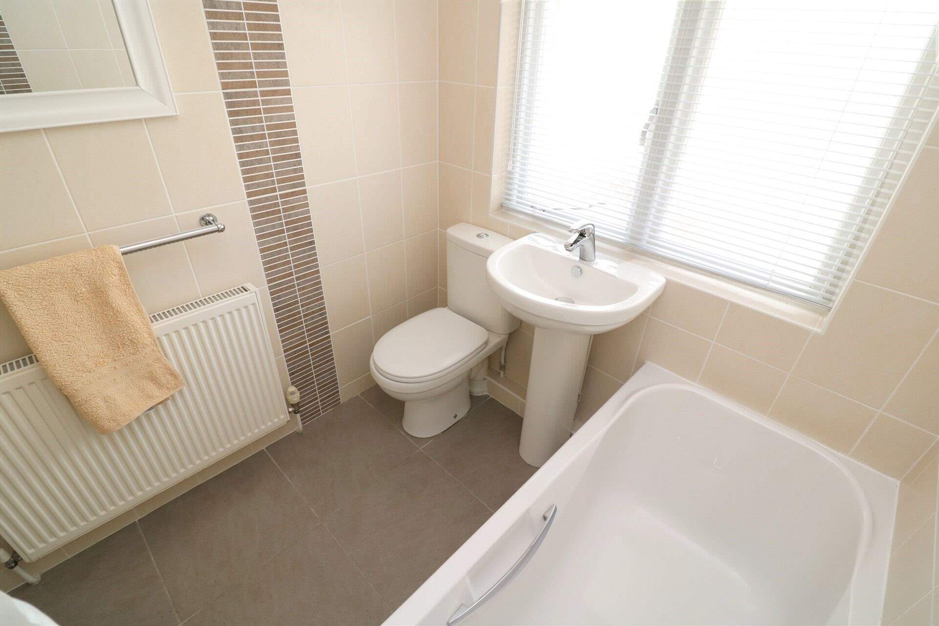 The family bathroom on the ground floor has a bath for a long soak after a busy beach day. 