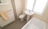 The family bathroom on the ground floor has a bath for a long soak after a busy beach day.  - Thumbnail Image