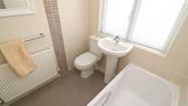 The family bathroom on the ground floor has a bath for a long soak after a busy beach day. 