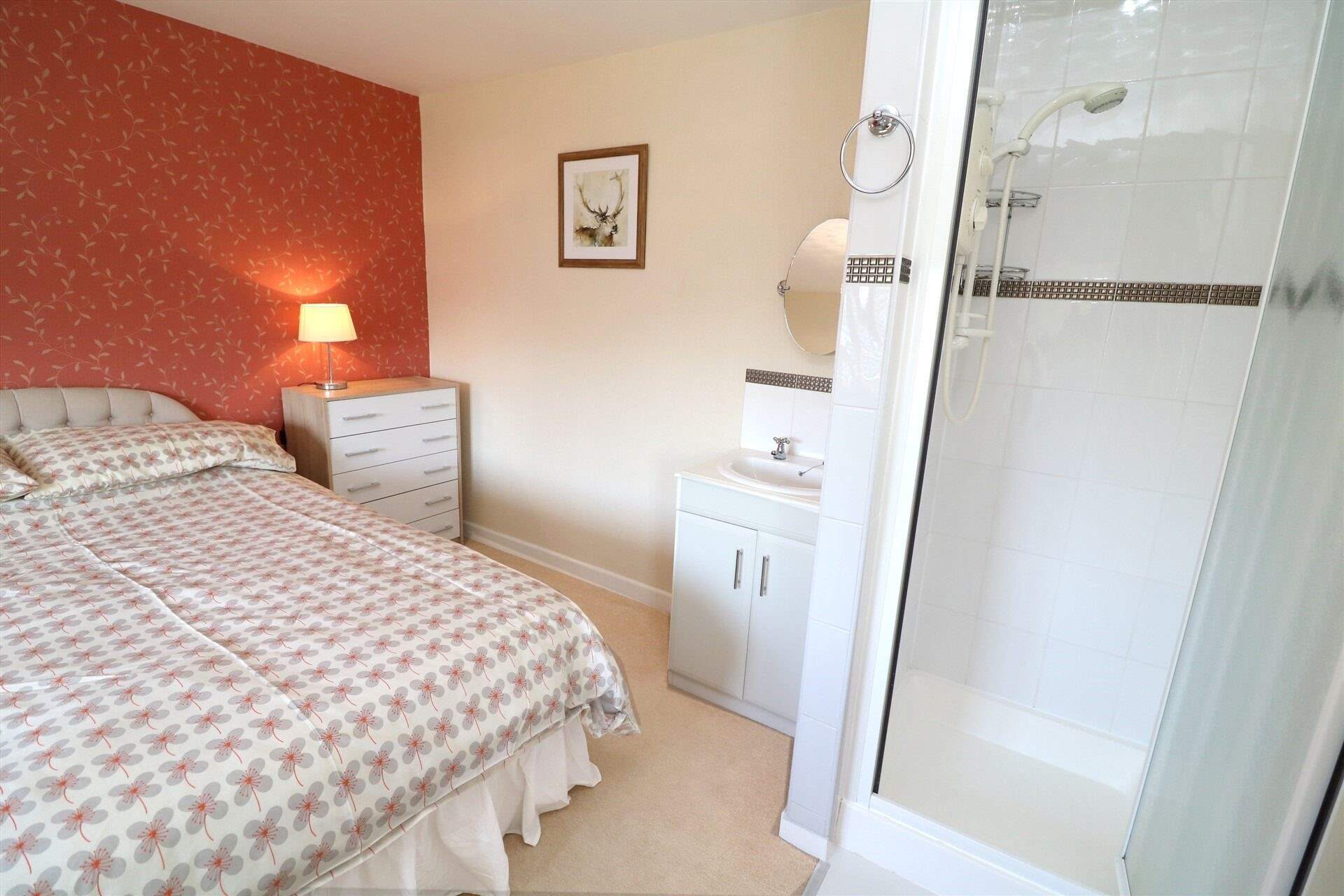 The double bedroom has a shower cubicle and wash-basin. 