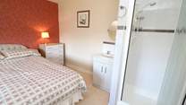 The double bedroom has a shower cubicle and wash-basin. 