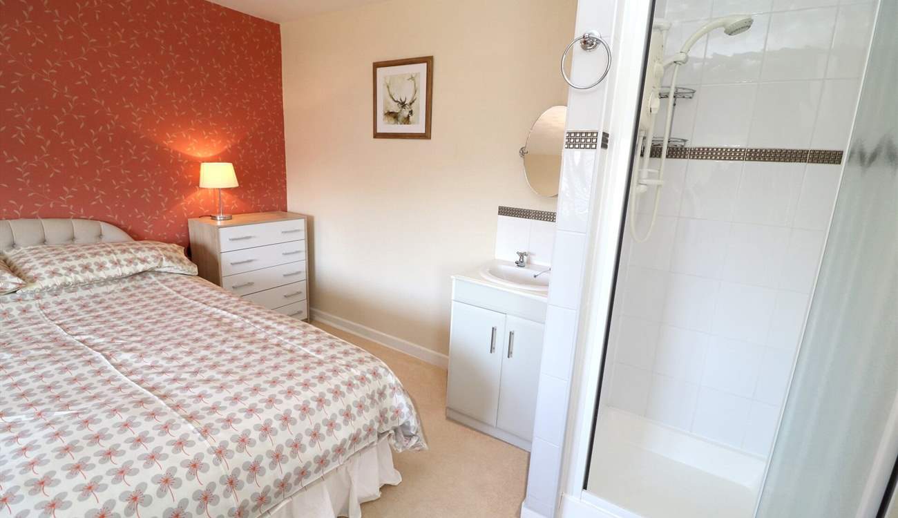 The double bedroom has a shower cubicle and wash-basin. 