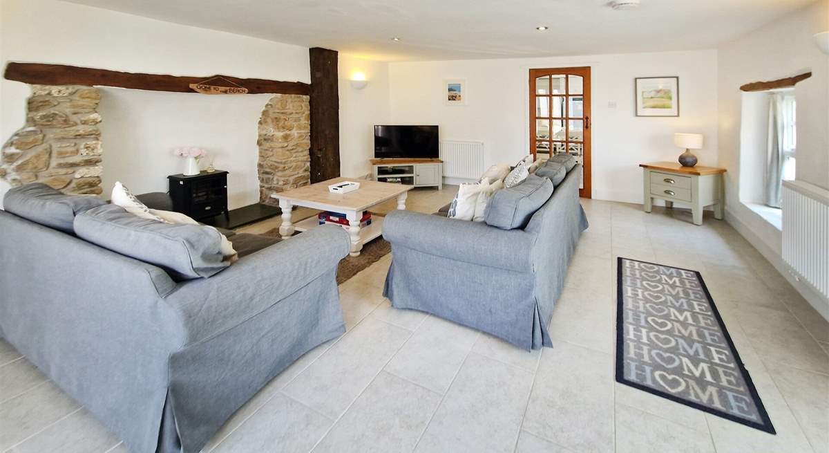 The sitting-room has plenty of space for everyone and the perfect flooring for the family pooch. 