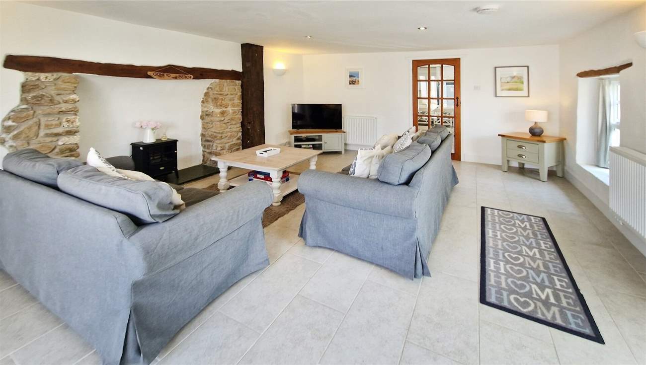 The sitting-room has plenty of space for everyone and the perfect flooring for the family pooch.
