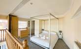 The third bedroom is on the mezzanine, with a four poster bed and an en suite shower-room. - Thumbnail Image