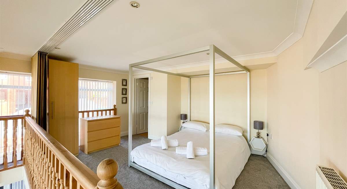 The third bedroom is on the mezzanine, with a four poster bed and an en suite shower-room.