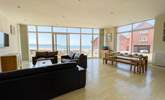 On the first floor, the open plan sitting/dining-room has beautiful sea views. - Thumbnail Image