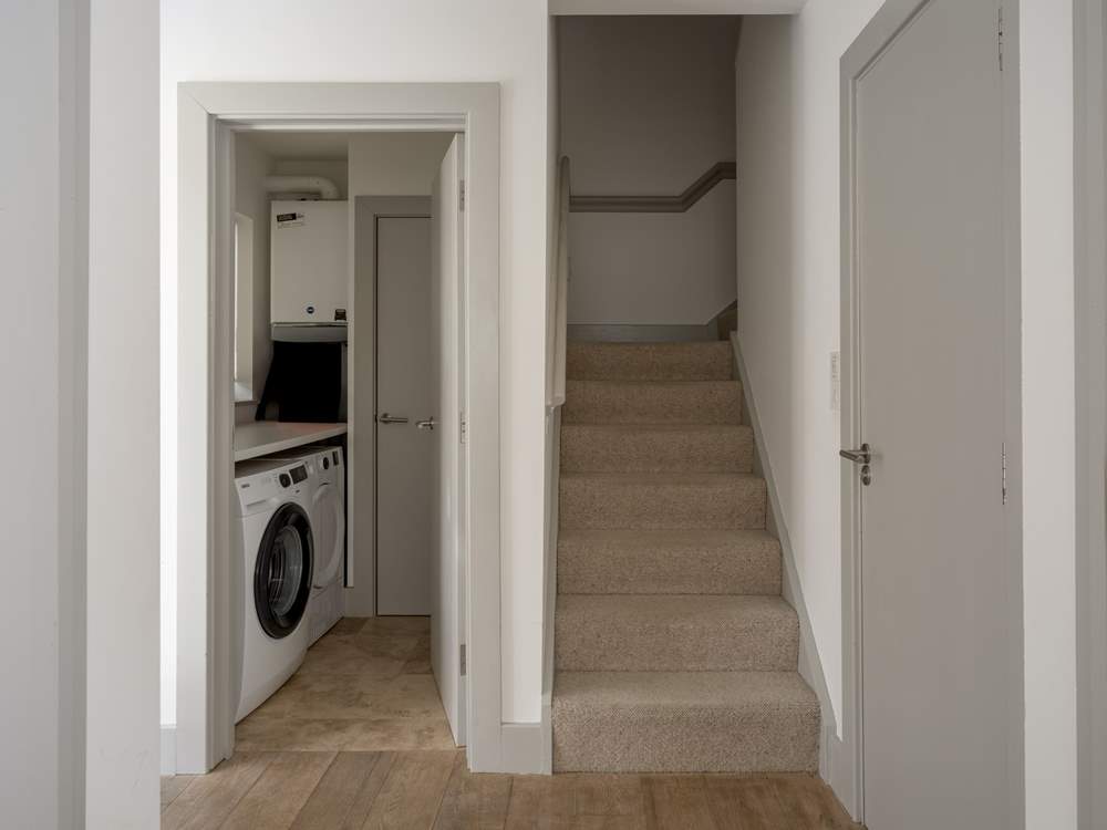 The handy utility-room on the left, the downstairs cloakroom on the right.