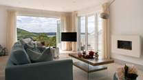 The sitting-room connects with the far reaching views.