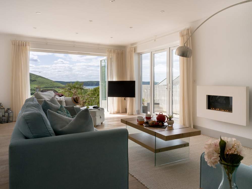 The sitting-room connects with the far reaching views.