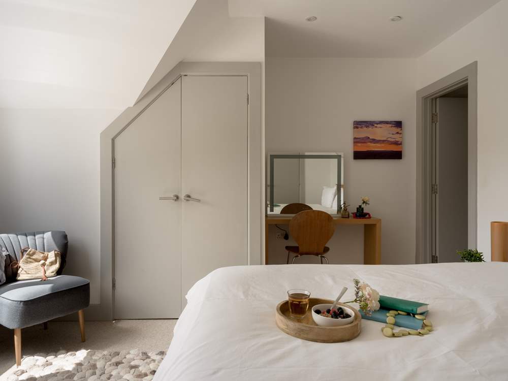 Bedroom 1 offers views out to the coast.