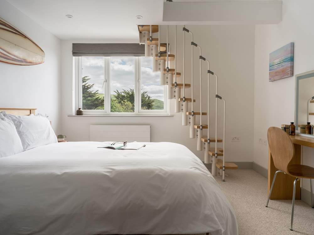 Bedroom 2 echoes the call of the surf that can be seen from the window, no matter the season. There is a mezzanine area that offers the perfect reading nook.