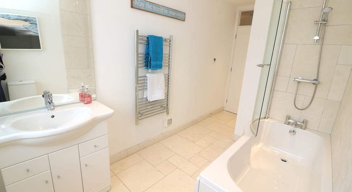 The family bathroom has a bath with fitted shower. 