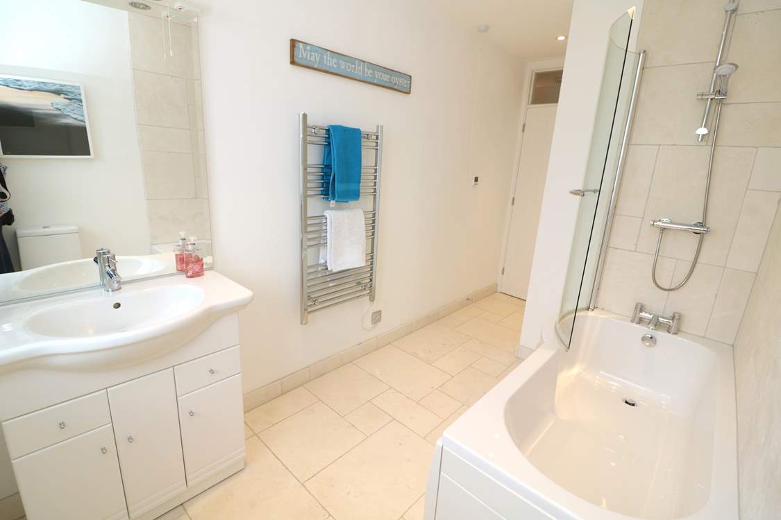 The family bathroom has a bath with fitted shower.