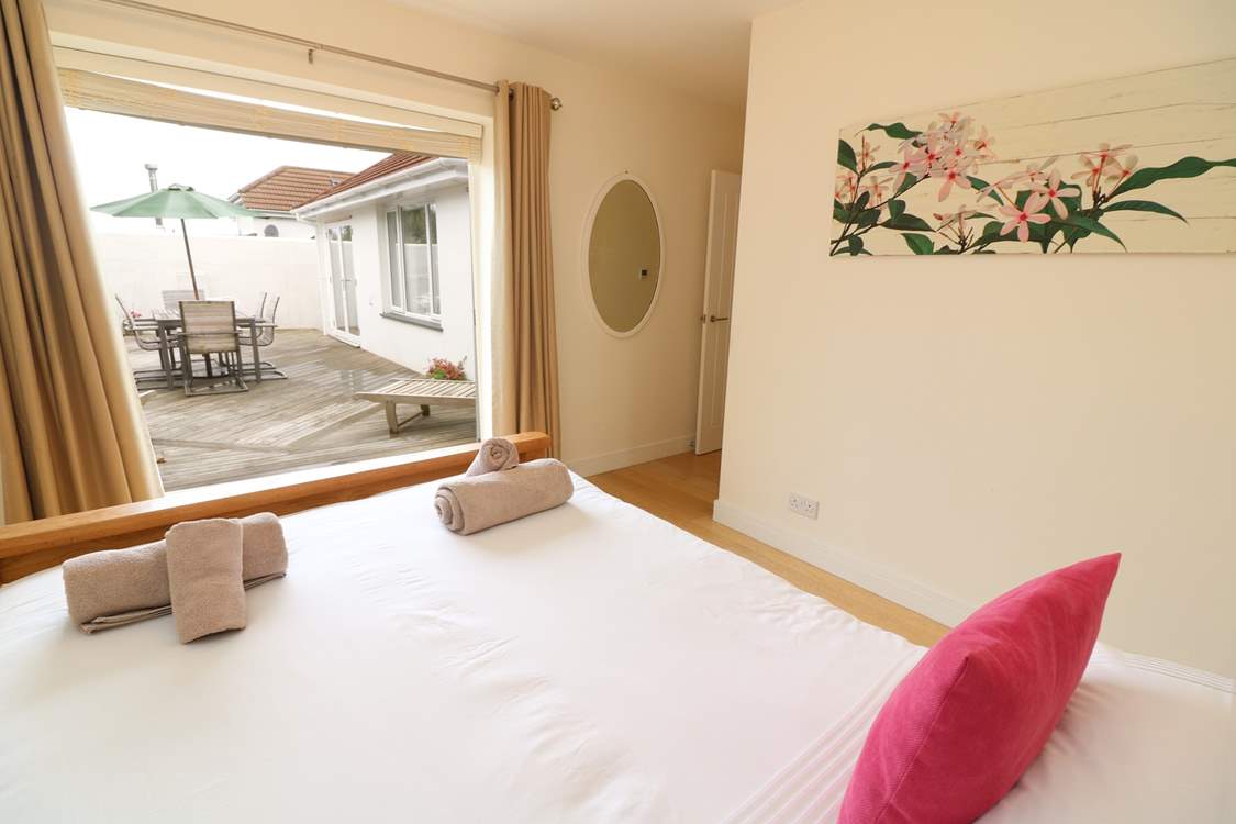 This gorgeous bedroom has access to the decked area.