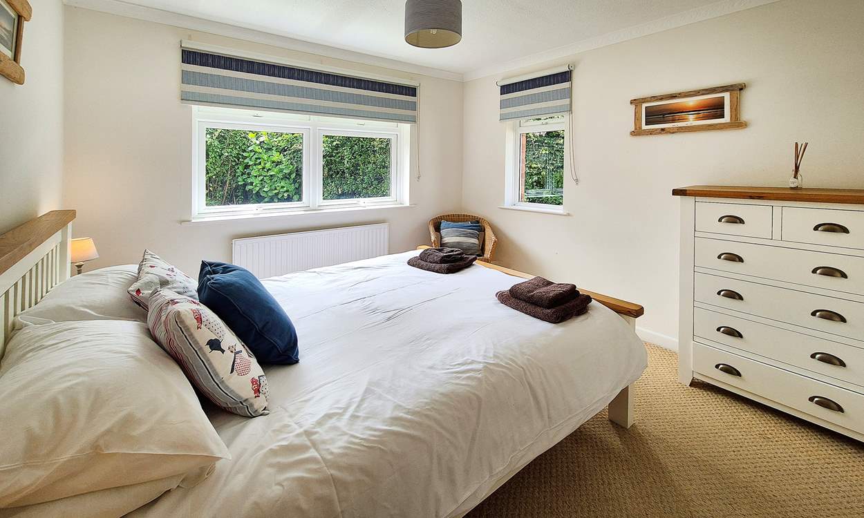 This bedroom has dual-aspect windows which look out into the garden.