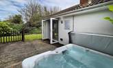 The hot tub sits on the deck area. - Thumbnail Image