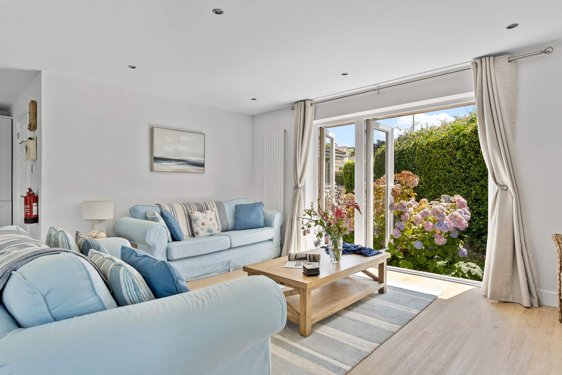 Welcome to Pebbles, coastal interiors await in the open plan living area. 