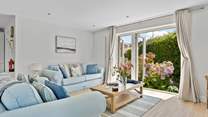 Welcome to Pebbles, coastal interiors await in the open plan living area. 