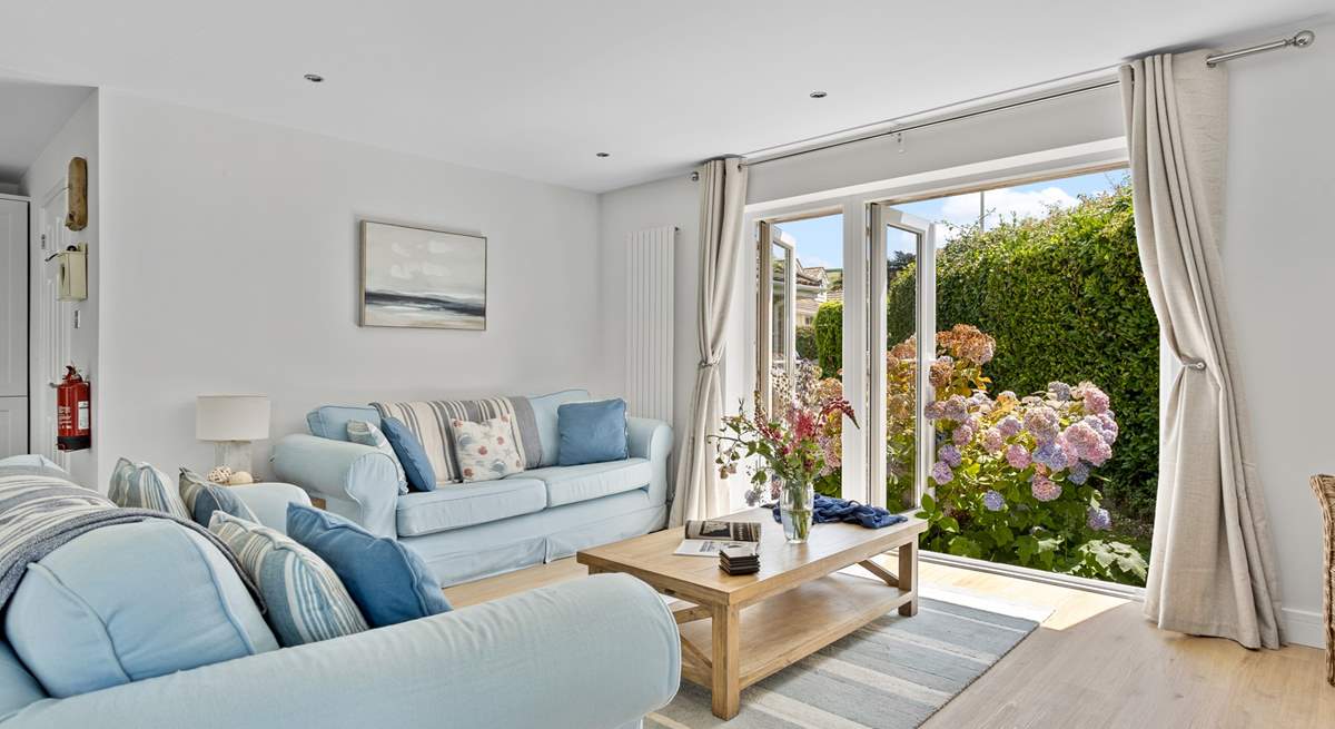 Welcome to Pebbles, coastal interiors await in the open plan living area. 