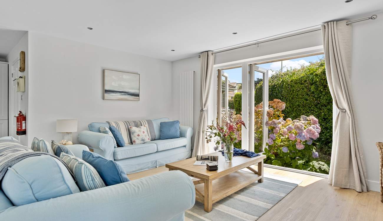 Welcome to Pebbles, coastal interiors await in the open plan living area. 