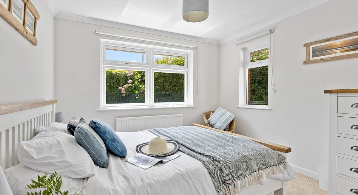 This bedroom has dual-aspect windows which look out into the garden. 