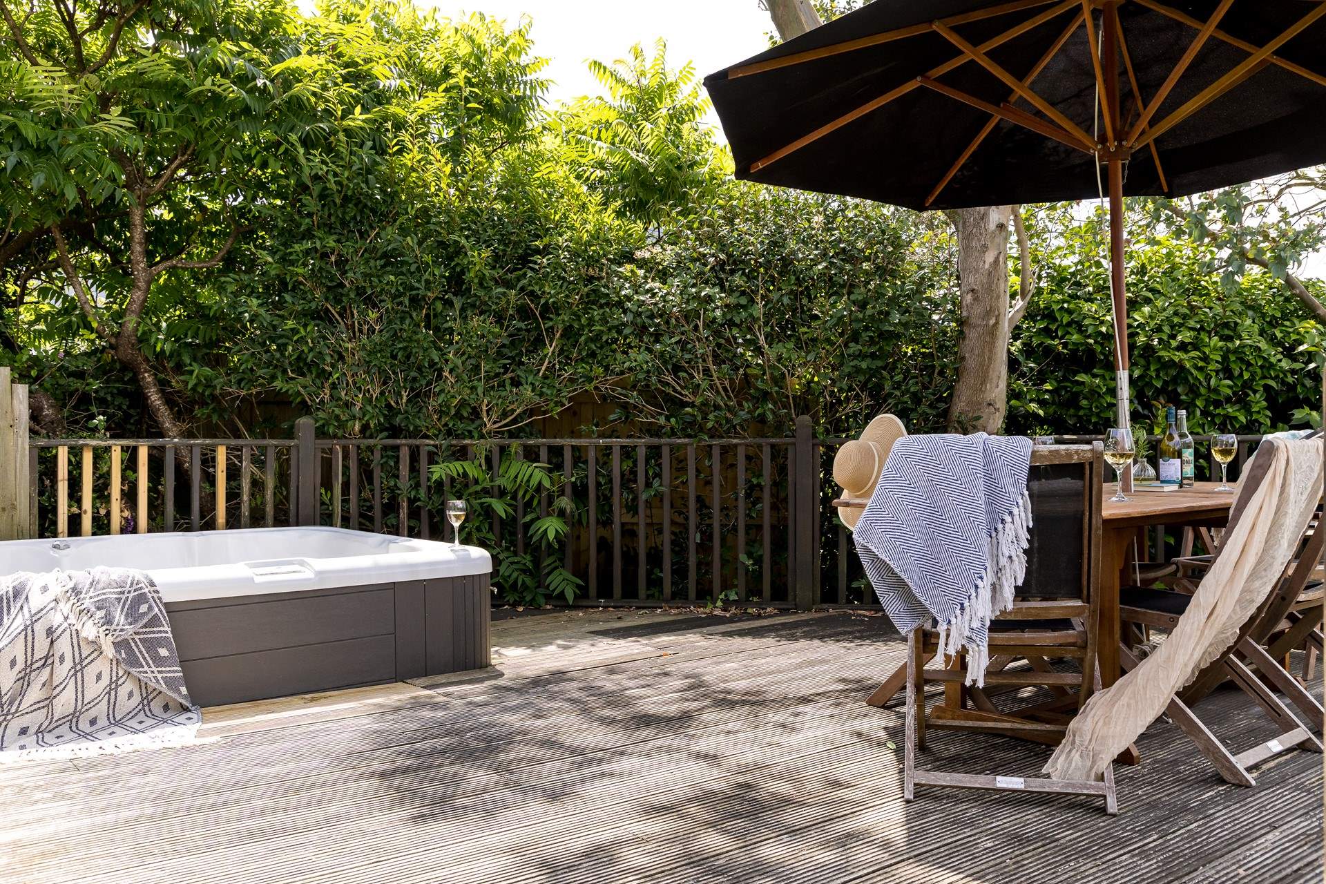 The pretty garden is home to a bubbling hot tub and outside furniture for al fresco dining. 