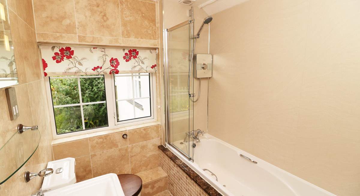 The family bathroom has a bath with fitted shower. 