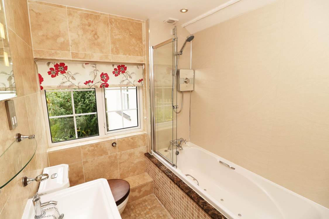 The family bathroom has a bath with fitted shower.