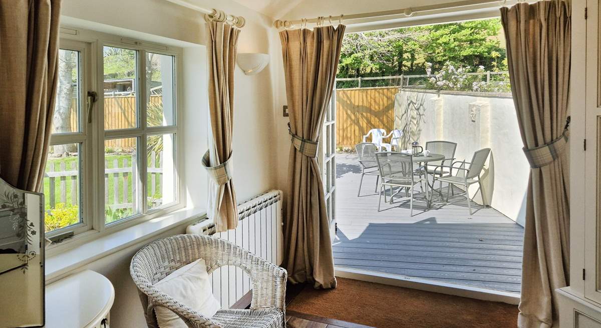 Fling open the French doors in bedroom one and step out on to the decked terrace.
