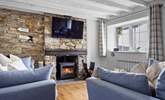 The cosy sitting-room has a wood-burner for those chillier seasons. - Thumbnail Image