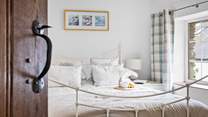Light and airy bedroom 2 has a double bed.